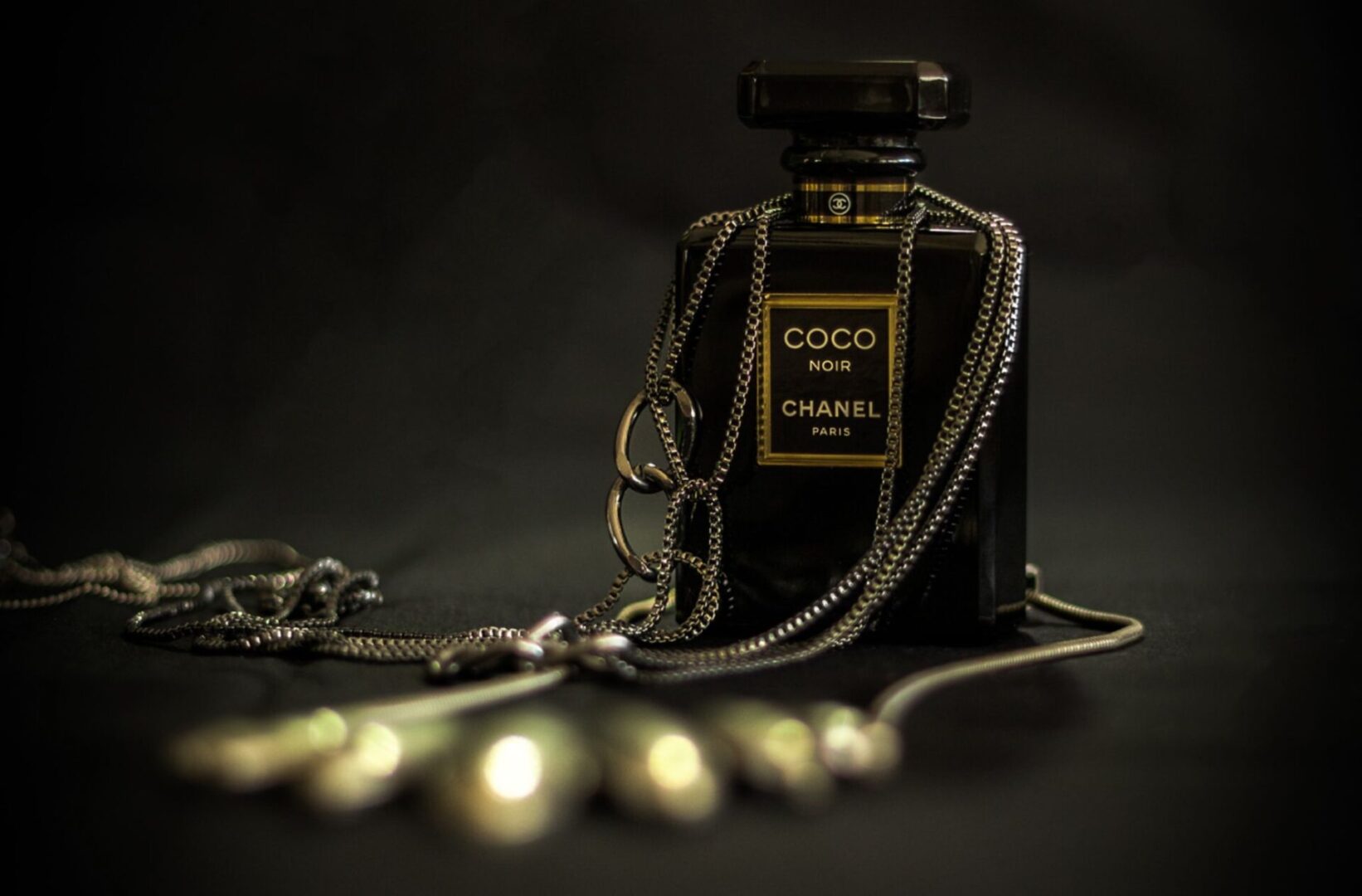 A bottle of coco chanel perfume sitting on top of a table.