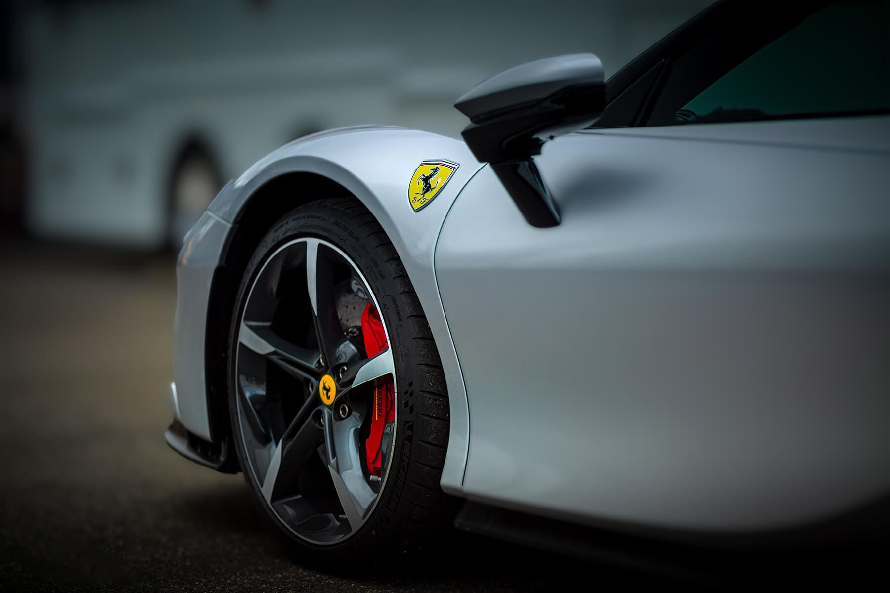 A close up of the wheel on a silver car