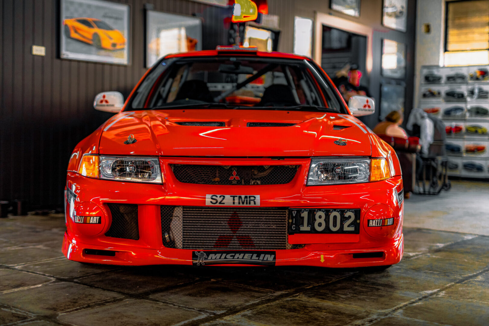 A red car parked in front of a building.